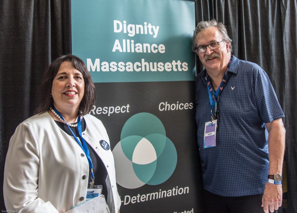 Lieutenant Governor Kim Driscoll with Paul Lanzikos in front of DignityMA banner.