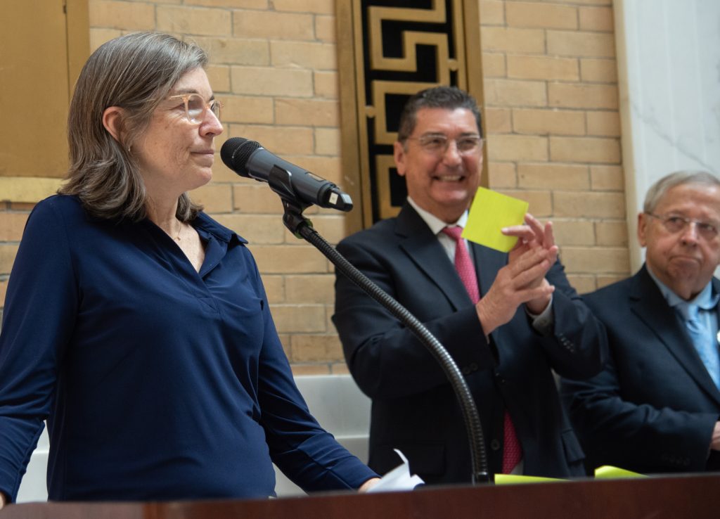 Betsey Crimmins with Mike Festa and Richard Moore in background